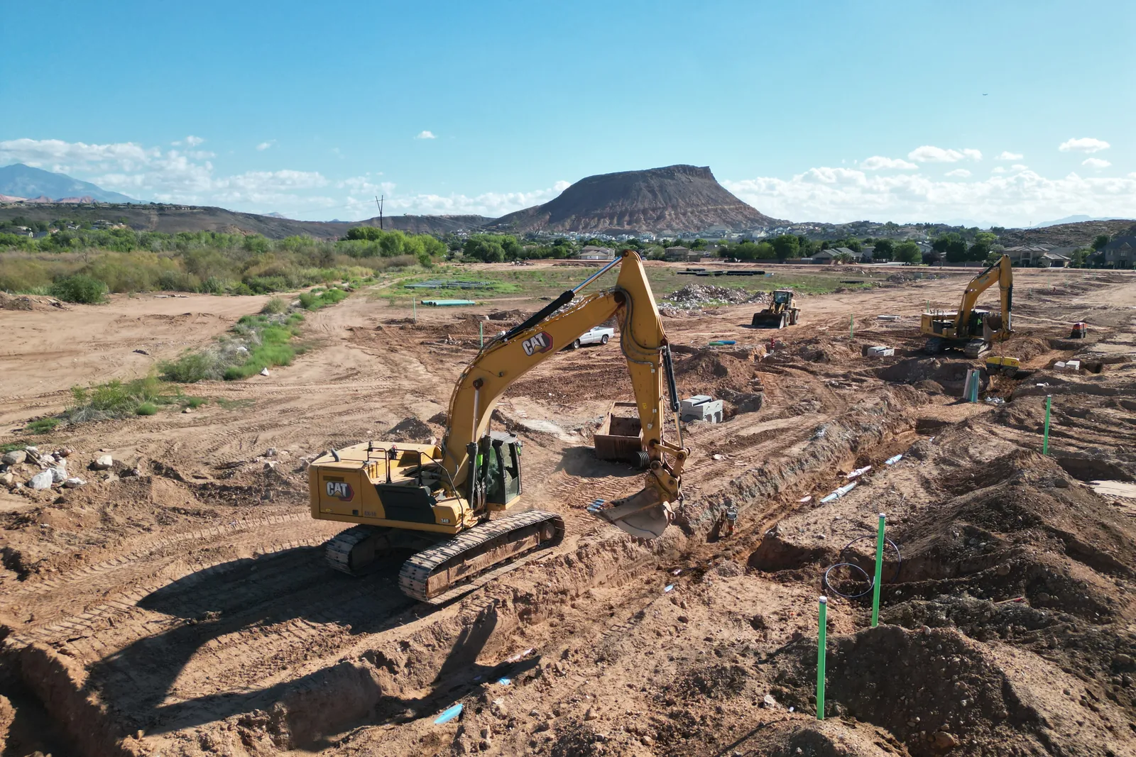 Aerial of the Stillwater site being graded, with a flat-topped mesa beyond