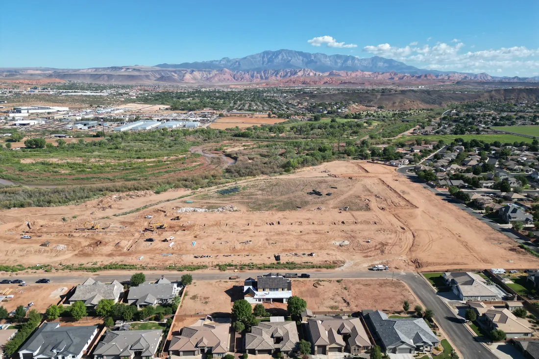 The valley and red rock ridge on the horizon above the Stillwater site